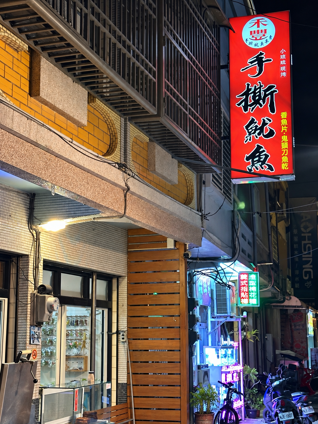 小琉球禾豐手撕魷魚紅色直式招牌，標示現烤魷魚與魚乾品項